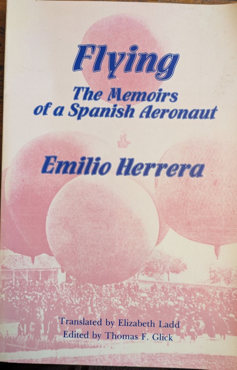 Picture of book's colour pictorial cover showing gas balloons inflated amongst a crowd with title and author above